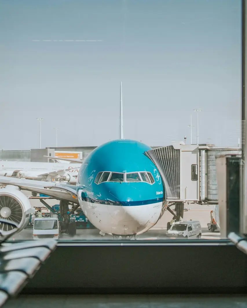 Airliner at a terminal gate seen from the departure lounge